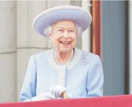  ?? JONATHAN BRADY/PA ?? Queen Elizabeth II smiles Thursday at London’s Buckingham Palace during the start of a four-day jubilee to celebrate her 70 years on the throne.