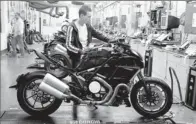  ?? By Alessandro Ruggeri, Afp/getty Images ?? Motorcycle­s: Assembly line at a Ducati factory in Bologna, Italy.