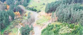  ?? ?? Drone photos show the slip, with the pavement almost down near the stream.