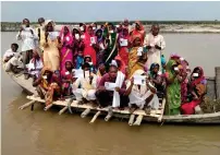  ?? PTI ?? Voters travel aboard an overloaded boat to reach their polling stations during the polls in Darbhanga district. —