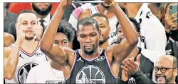  ?? Getty Images ?? JAMMED! Kevin Durant lifts the All-Star Game MVP award after outpacing Giannis Antetokoun­mpo, who reached into the heavens to throw down a big alley-oop dunk in the first half.