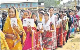  ?? PTI ?? Voters wait in queue to cast their votes at a polling booth in Raj Nagar, Agartala, on Sunday.