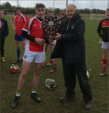  ??  ?? Paddy Barron receiving the shield from Pat Henderson, South Leinster Schools Servicing Officer.