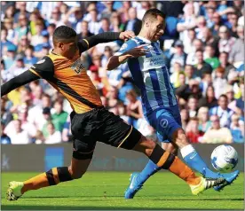  ??  ?? DENIED: Curtis Davies of Hull gets across to tackle Brighton’s Sam Baldock