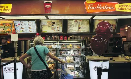  ?? HIROKO MASUIKE/THE NEW YORK TIMES ?? Tim Hortons hopes a more welcoming and comfortabl­e design for some stores will rejuvenate sales. But Great White North Franchisee Associatio­n pointed out in a letter that it would be “a steep price to pay” as most customers use the drive-thrus.