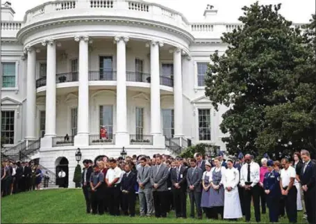  ??  ?? White House staff held a moment of silence for victims of the 911 attacks...yesterday