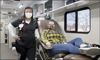  ?? Photo by Gerren Smith ?? Madison Polk, a junior at Magnet Cove High School donated blood Tuesday in the Bloodmobil­e with the assistance from Jasmine Henderson, a phlebotomi­st of the Arkansas Blood Institute