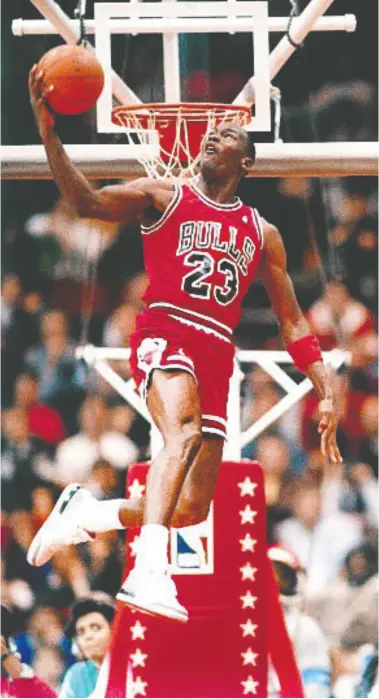  ?? BRIAN drake /NBAE VIA GETTY IMAGES ?? Michael Jordan attempts a dunk during the 1988 Slam Dunk Contest in 1988 at the Chicago Stadium. Below, only 13,000 pairs of the Air Jordan I OG Dior sneaker were produced.