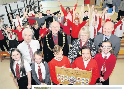  ??  ?? Prize Celebratin­g pupils are joined by winning team Tamera McOmish, Mercedes McBride, Nathan Ward, Sinead McCallion and Morgan Patterson, head teacher Jim McShane, Bishop Idris Jones and Late Collector Ruth Maltman