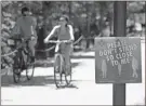  ?? Ap-john Bazemore ?? A sign asked people to maintain social distance as they enjoy the warm weather on the Beltline in Atlanta’s Inman Park neighborho­od Friday.