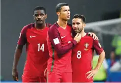  ??  ?? Portugal’s forward Cristiano Ronaldo (C) Portugal’s midfielder William (L) and Portugal’s midfielder Joao Moutinho react after their defeat during the 2017 Confederat­ions Cup semi-final football match between Portugal and Chile at the Kazan Arena in...