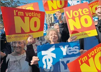  ??  ?? ENGAGED IN DEBATE: Yes and No supporters pictured in Glasgow during the last few days of the Scottish independen­ce referendum campaign in September, 2014. Picture: Mark Runnacles/Getty Images