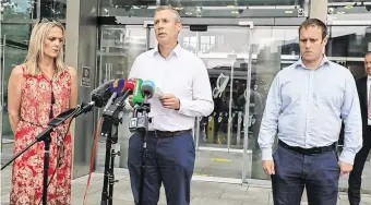  ?? PHOTO: COLLINS PHOTO ?? ‘Immense gratitude’: Colm Donohoe makes a statement flanked by his sister, Mary, and brother, Martin, outside the Criminal Courts of Justice yesterday.