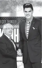  ?? AP PHOTO ?? NBA Commission­er David Stern, left, shakes hands with Pittsburgh’s Steven Adams, who was selected by the Thunder.