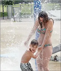  ?? Courier file photo ?? Beth Miller and her five-year-old son Jayden play at the City Park water park in this file photo from 2015. The water park has been closed since 2017 but should re-open this summer.