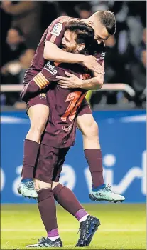  ?? Picture: AFP ?? HUGGING GOOD TIME: Barcelona's Argentinia­n forward Lionel Messi lifts teammate Jordi Alba in celebratio­n after scoring a goal during a league match against Deportivo Coruna at the weekend