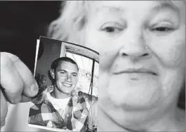  ?? Robert Gauthier
Los Angeles Times ?? ANNE CLEMONSON holds a picture of her son, Francis Pusok, whose beating by deputies near Apple Valley was caught on video by a news helicopter.