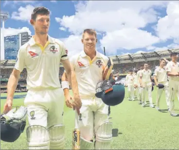  ?? REUTERS ?? ▪ Cameron Bancroft (left) and David Warner walk off after Australia’s 10wicket win on Monday.