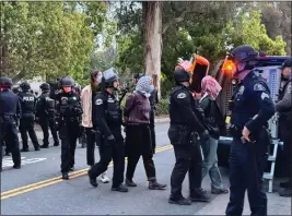  ?? DAVID ALLEN — STAFF ?? Police detain protesters near a transport vehicle on Friday at Pomona College in Claremont. An earlier protest was organized by the student-led group Pomona Divest Apartheid.