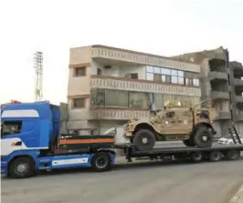  ??  ?? RAQA: A military convoy composed of 140 trailers used to carrying US-made armoured vehicles, bulldozers, and arms, through Simalka border crossing between Syria and Iraqi Kurdistan, and headed for SDF forces fighting. —AFP