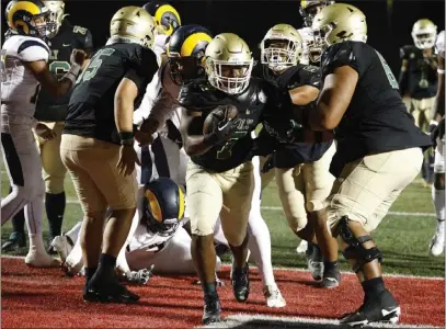  ?? PHOTO BY TRACEY ROMAN ?? Poly's Joshua Cason runs for a touchdown during Friday night's Moore League game against Millikan in Long Beach.