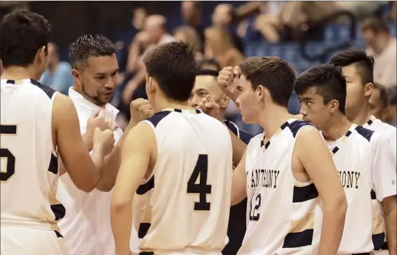  ?? The Maui News / CHRIS SUGIDONO photos ?? St. Anthony High School coach Darren Aguinaldo talks to his players during a second-quarter timeout Friday at War Memorial Gym