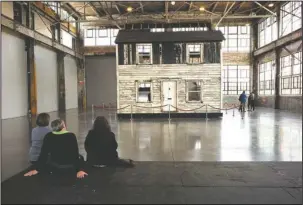  ?? The Associated Press ?? HISTORY FOR SALE: Visitors view the rebuilt house of Rosa Parks at the WaterFire Arts Center on April 1 in Providence, R.I. The house where Parks sought refuge in Detroit after fleeing the South will be auctioned after being turned into a work of art....