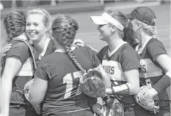  ?? Jason Fochtman / Conroe Courier ?? Foster starting pitcher Kacie Pryor, second from left, celebrates with teammates after defeating Arlington Heights 8-1 in a Class 5A state semifinal game.