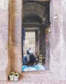  ??  ?? An Ethiopian Christian Orthodox priest praying at one of the rock-hewn churches in Lalibela