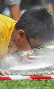  ??  ?? Blowing hard: A young boy gets his face in a mess during a fun game in Kuching.