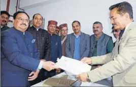  ?? DEEPAK SANSTA /HT ?? Union health minister JP Nadda submitting his nomination papers in the Vidhan Sabha in Shimla on Thursday as Himachal CM Jai Ram Thakur (second from left) looks on.