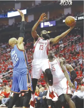  ??  ?? Rockets guard James Harden, who had a team- high 35 points, drives in for a layup against the Thunder’s Taj Gibson in Game 2 on Wednesday in Houston.
| GETTY IMAGES