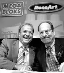  ??  ?? Rose Art Industries CEO Lawrence Rosen, right, and Mega Bloks CEO Marc Bertrand shake hands last year. Mega Bloks’ profit rose 45 per cent, augmented by the acquisitio­n of Rose Art in late July. Mega Bloks