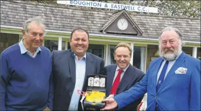  ??  ?? Boughton & Eastwell Cricket Club chairman Ian Foinette (right) receives the defibrilla­tor, with club secreatary Mike Carney parish council chairman James Matthews and Kent County councillor Charlie Simpkins