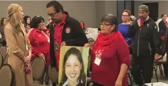  ?? STEVE LAMBERT/THE CANADIAN PRESS FILE PHOTO ?? Bernice Catcheway carries a picture of missing daughter Jennifer into a hearing of the national inquiry into missing and murdered women in Winnipeg last month. Catcheway’s family feel that police have abandoned their case.