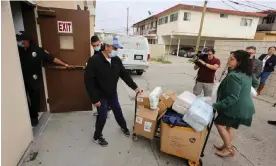  ?? Photograph: David Swanson/AFP/Getty ?? Volunteers deliver supplies to the St Anthony Croatian Catholic Church, where migrants were taken to after arriving at Union Station in LA.
Images