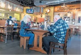  ??  ?? Nancy and husband Rick Phillips enjoy lunch at the Glen Burnie Mission BBQ, which is set up so that customers go from order to table within 10 minutes.