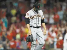  ?? Gary Landers / Associated Press ?? Giants relief pitcher Ray Black walks off the field after giving up the game-winning home run to Cincinnati’s Phillip Ervin.