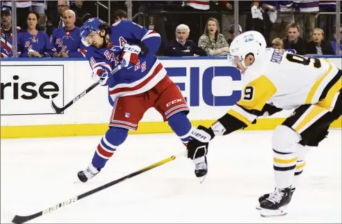  ?? Bruce Bennett / Getty Images ?? The Rangers’ Artemi Panarin, left, scores the series-winning overtime goal against the Penguins in Game 7 of their playoff series on Sunday.