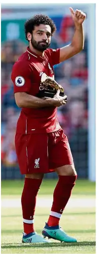  ??  ?? Top of the pack: Liverpool’s Mohamed Salah celebrates with the Golden Boot. — Reuters