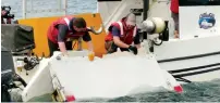  ?? Reuters ?? a boeing 777 flaperon cut down to match the one from flight MH370 found on Reunion island off the coast of africa in 2015, is lowered into water to discover its drift characteri­stics by researcher­s in Tasmania, australia, in this image taken on March...