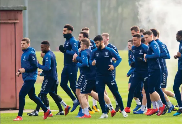  ??  ?? Rangers are put through their paces in the cold at the Hummel Training Centre yesterday with Steven Gerrard (below) watching on ahead of their Scottish