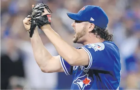  ?? FRANK GUNN, THE CANADIAN PRESS ?? Blue Jays reliever Jason Grilli is pumped up after the final out of the eighth inning of Game 4 against the Indians in Toronto on Tuesday. Grilli, Brett Cecil and Roberto Osuna all pitched scoreless innings in relief.