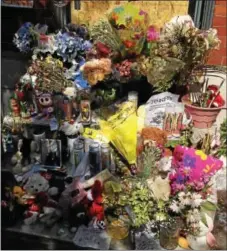 ?? CARL ROTENBERG — DIGITAL FIRST MEDIA ?? Dozens of flower bouquets, children’s drawings and stuffed animals have been added to the stoop of the home in the 800 block of DeKalb Street in Norristown Friday, May 20, where an early-morning fire on May 7 resulted in the deaths of four people.