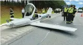  ?? MONCURE FIRE DEPARTMENT ?? Emergency personnel and law enforcemen­t look over the scene after a small plane made an emergency landing Thursday along Route 1 in Moncure, N.C.