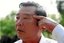  ??  ?? Pham Thanh Cong, left, points at a scar caused by grenade fragments during the My Lai massacre.