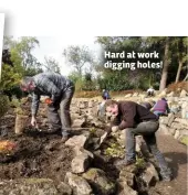  ??  ?? Hard at work digging holes!