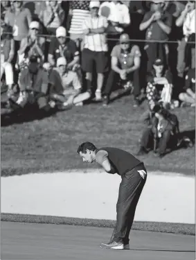  ?? CHRIS CARLSON/AP PHOTO ?? Europe’s Rory McIlroy, playing with Thomas Pieters, bows after making an eagle putt to clinch a 3 &amp; 2 win over Dustin Johnson and Matt Kuchar on Friday in a four-balls match at the Ryder Cup in Chaska, Minn. Europe, which trailed 4-0 after the morning foursomes, won the afternoon session 3-1 and now trails the United States 5-3.