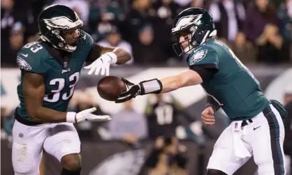  ??  ?? Philadelph­ia quarterbac­k Carson Wentz hands off to running back Josh Adams during Monday’s win over Washington. Photograph: Bill Streicher/USA Today Sports