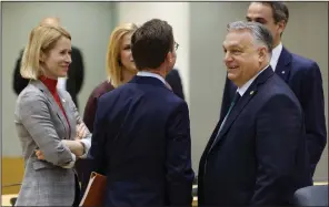  ?? (AP/Geert Vanden Wijngaert) ?? Viktor Orban, Hungary’s Prime Minister (right), talks to Finland’s Prime Minister Petteri Orpo (center) next to Estonia’s Prime Minister Kaja Kallas (left) during a round-table meeting at an EU summit in Brussels on Thursday.